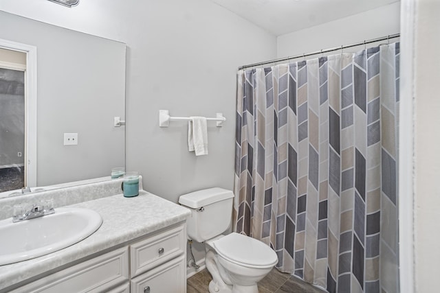 bathroom featuring hardwood / wood-style floors, vanity, a shower with shower curtain, and toilet