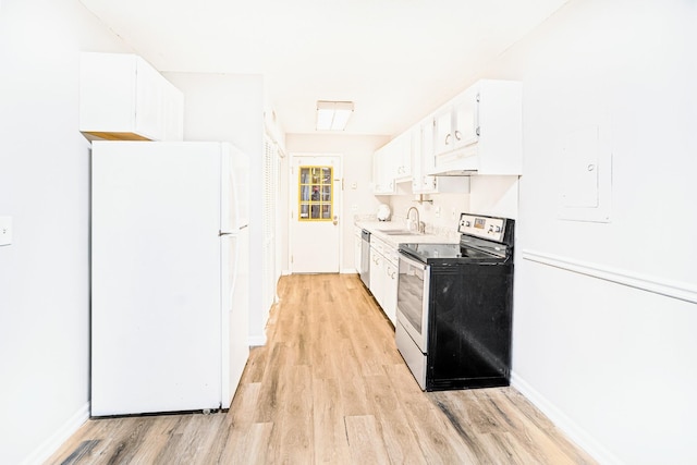 kitchen with white cabinets, sink, appliances with stainless steel finishes, and light hardwood / wood-style flooring