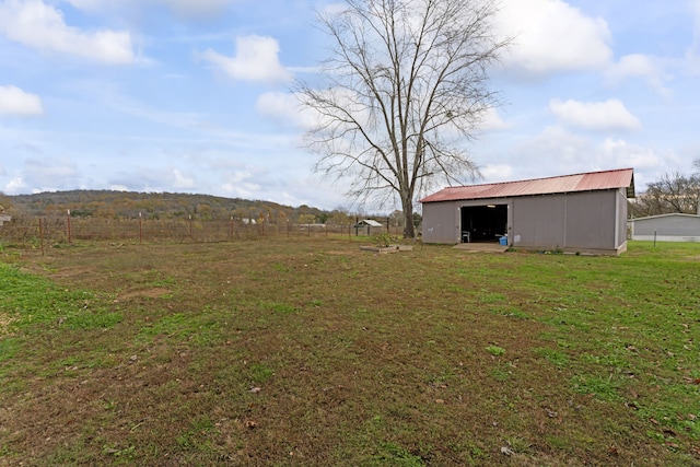 view of yard with an outbuilding and a rural view