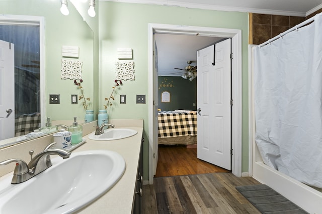 bathroom with ceiling fan, hardwood / wood-style flooring, vanity, and ornamental molding