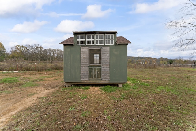 view of outdoor structure with a rural view