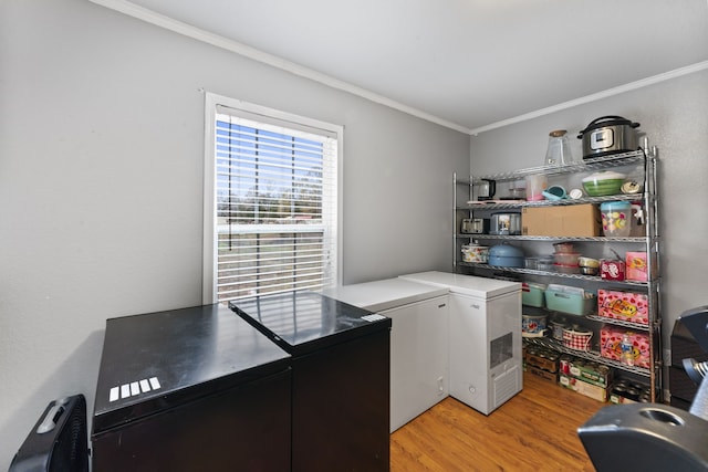 washroom with washer and dryer, light hardwood / wood-style floors, and crown molding