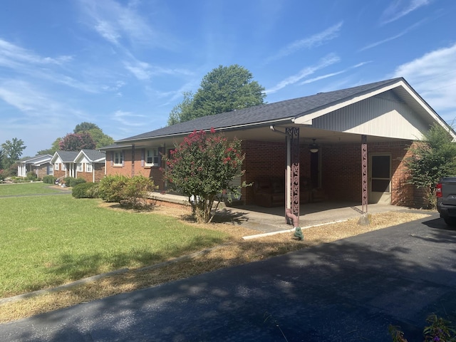1433 Cardinal Dr, Lafayette, TN 37083 - view of home's exterior featuring a lawn, brick siding, and an attached carport