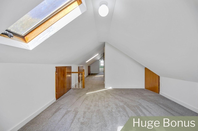 bonus room with carpet flooring and lofted ceiling with skylight