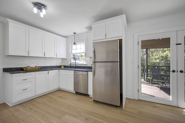 kitchen featuring white cabinets, light hardwood / wood-style flooring, stainless steel appliances, and sink