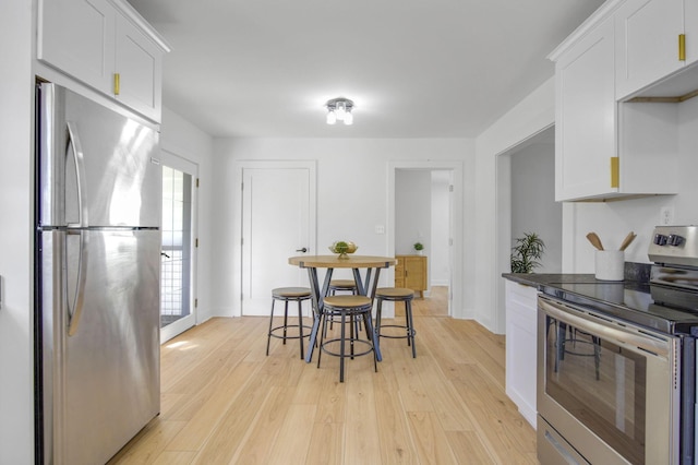 kitchen featuring light hardwood / wood-style floors, white cabinetry, and stainless steel appliances