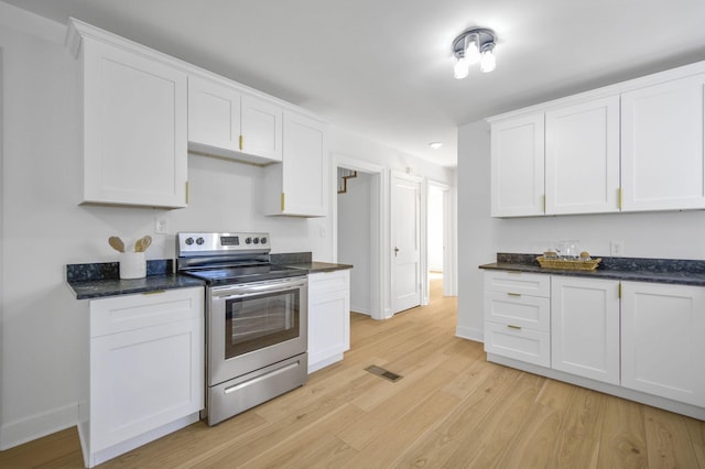 kitchen with electric stove, light hardwood / wood-style flooring, and white cabinets