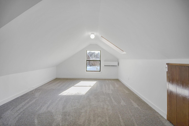 bonus room with light colored carpet, a wall unit AC, and vaulted ceiling with skylight