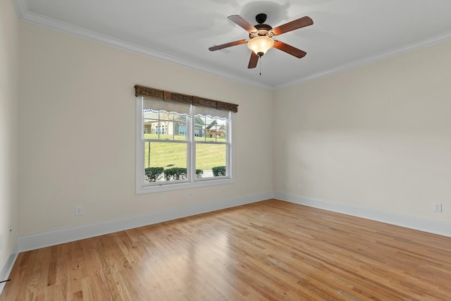 spare room featuring ceiling fan, ornamental molding, and light wood-type flooring