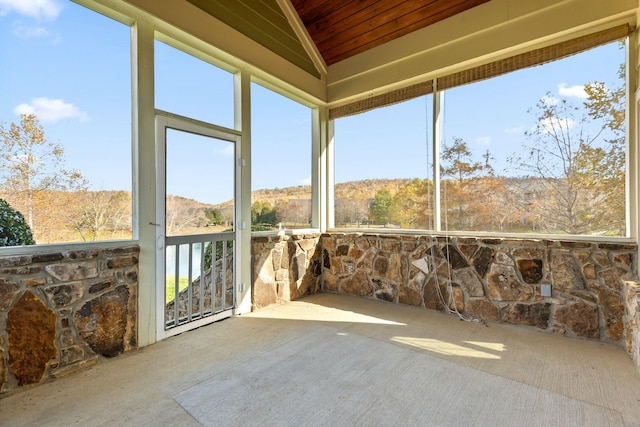 sunroom / solarium featuring vaulted ceiling and wood ceiling