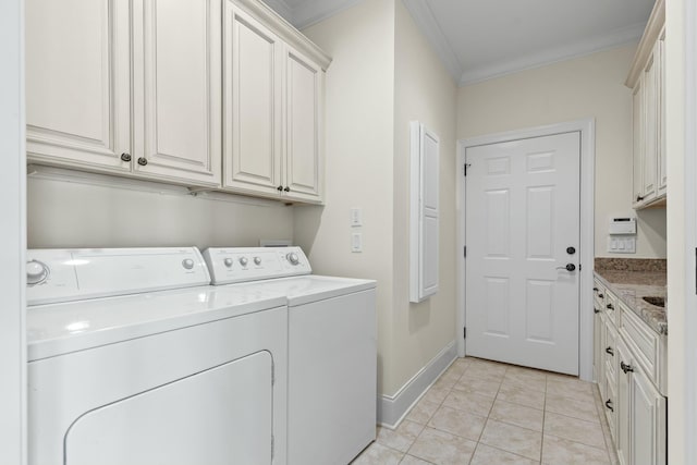 clothes washing area featuring crown molding, light tile patterned floors, cabinets, and independent washer and dryer