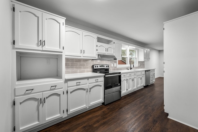 kitchen featuring tasteful backsplash, under cabinet range hood, light countertops, stainless steel appliances, and white cabinetry