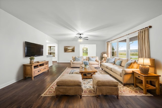 living room featuring ceiling fan and dark hardwood / wood-style floors