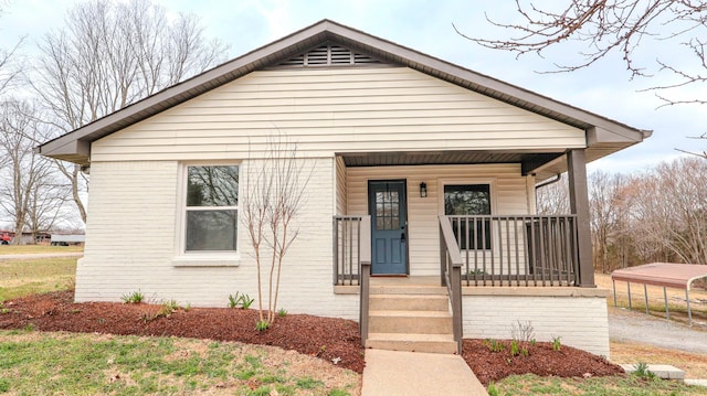 bungalow with brick siding and a porch