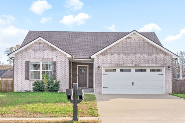 view of front of house with a garage and a front lawn