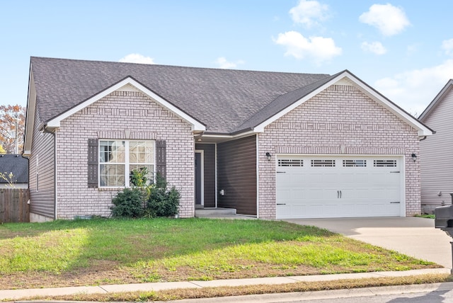 view of front of property featuring a front yard and a garage