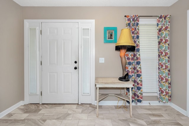 foyer entrance with a textured ceiling