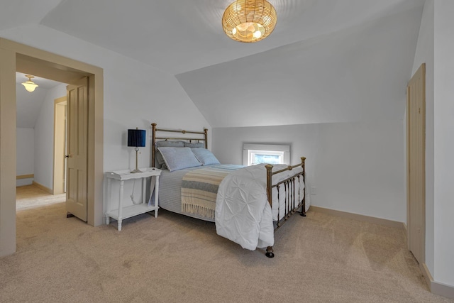 carpeted bedroom featuring vaulted ceiling