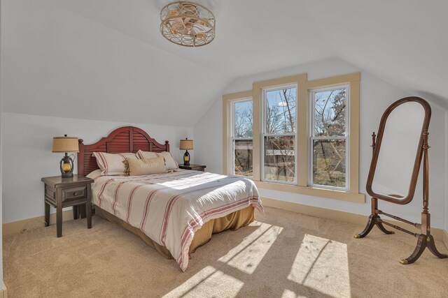 carpeted bedroom featuring lofted ceiling