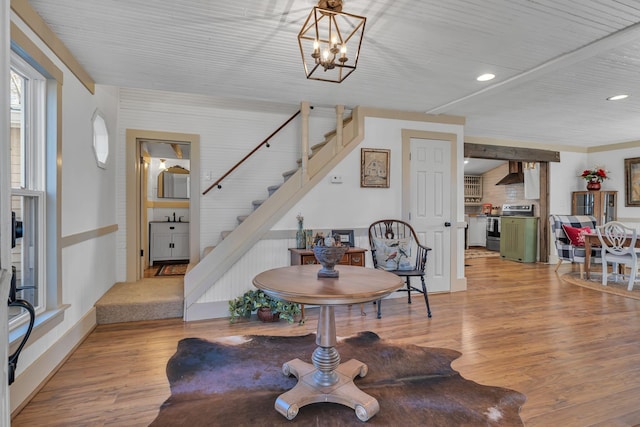 interior space featuring sink, light hardwood / wood-style floors, and an inviting chandelier