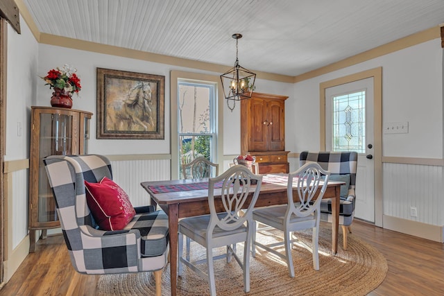 dining area with an inviting chandelier and hardwood / wood-style flooring