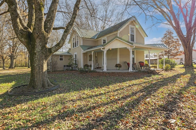 view of front of property with a porch and a front yard