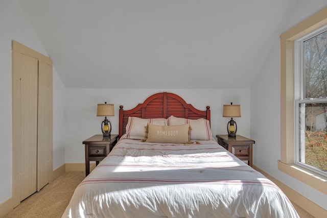 carpeted bedroom featuring vaulted ceiling