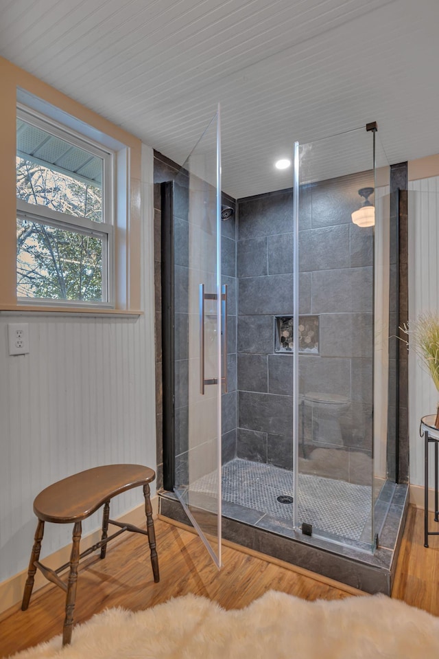 bathroom featuring hardwood / wood-style flooring and wooden walls