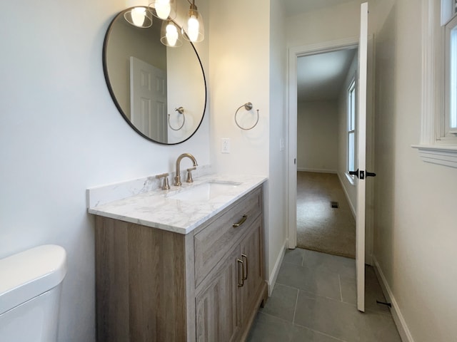 bathroom with tile patterned floors, vanity, and toilet