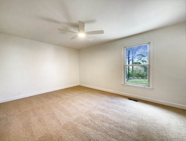 carpeted spare room with ceiling fan