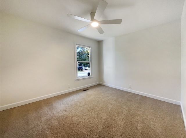 carpeted spare room with ceiling fan