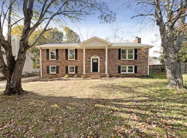 split foyer home with a front lawn