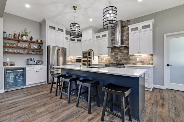 kitchen with sink, wine cooler, wall chimney exhaust hood, dark hardwood / wood-style flooring, and stainless steel appliances