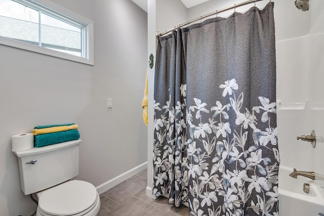 bathroom with tile patterned flooring, shower / tub combo, and toilet