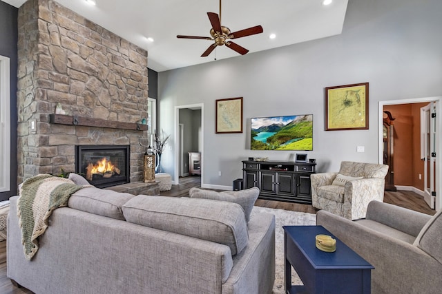 living room featuring a fireplace, ceiling fan, and hardwood / wood-style floors