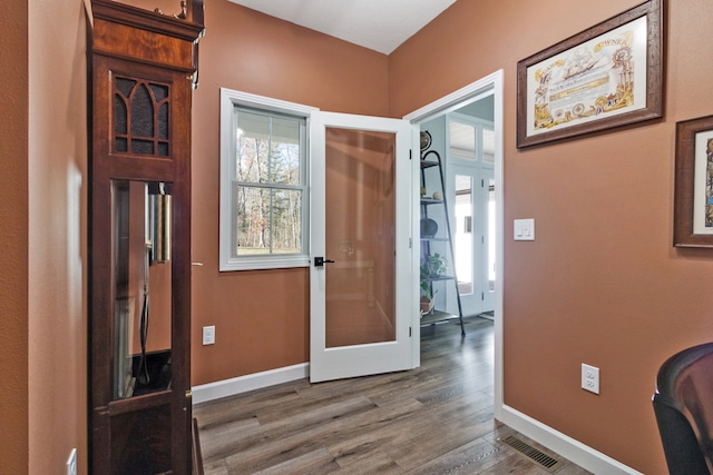 entryway with hardwood / wood-style floors and french doors