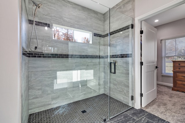 bathroom with tile patterned flooring, a healthy amount of sunlight, and walk in shower