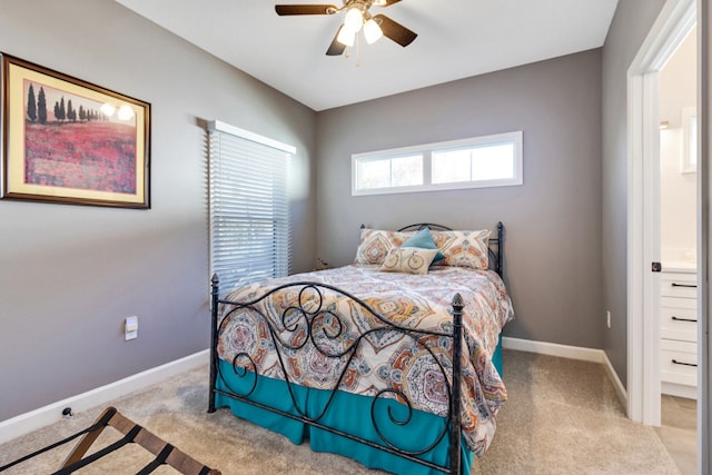 bedroom featuring connected bathroom, ceiling fan, and light colored carpet