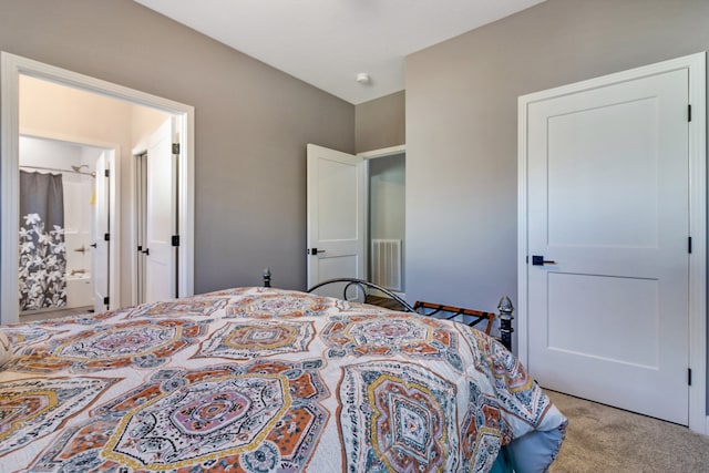 carpeted bedroom with ensuite bathroom