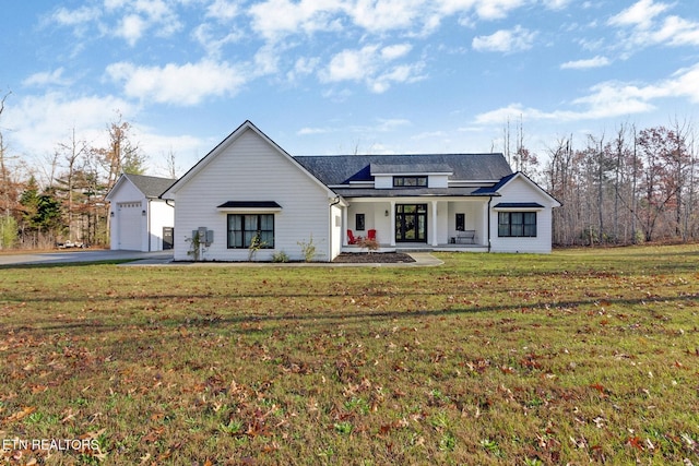 modern farmhouse style home featuring covered porch, a garage, and a front lawn