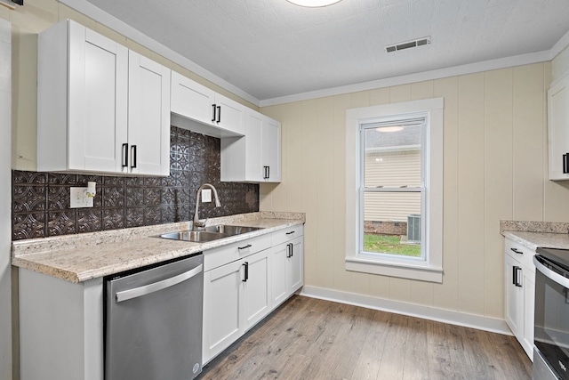 kitchen featuring stainless steel appliances, white cabinetry, light hardwood / wood-style floors, and sink