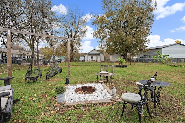 view of yard with a fire pit