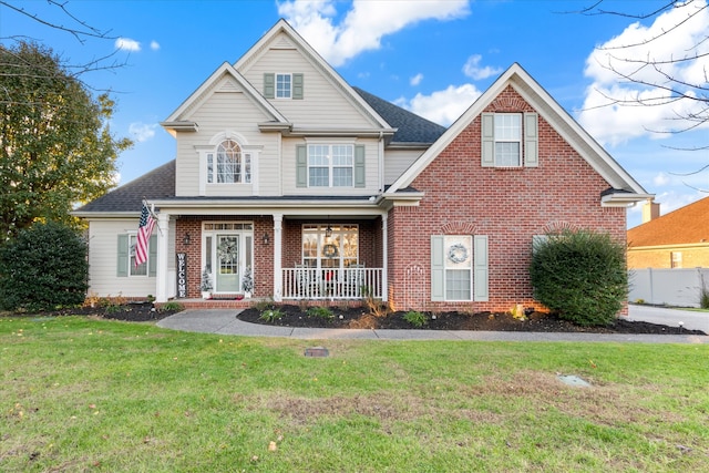 view of front of house featuring covered porch and a front lawn