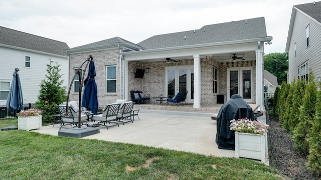 rear view of house with french doors, a yard, ceiling fan, and a patio area