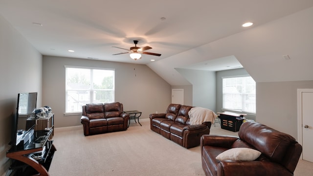 carpeted living room featuring ceiling fan, a wealth of natural light, and vaulted ceiling