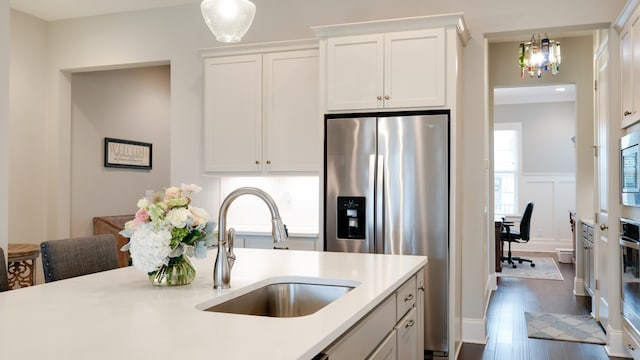 kitchen featuring dark hardwood / wood-style flooring, white cabinetry, sink, and appliances with stainless steel finishes