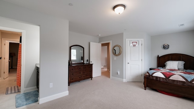 carpeted bedroom with connected bathroom