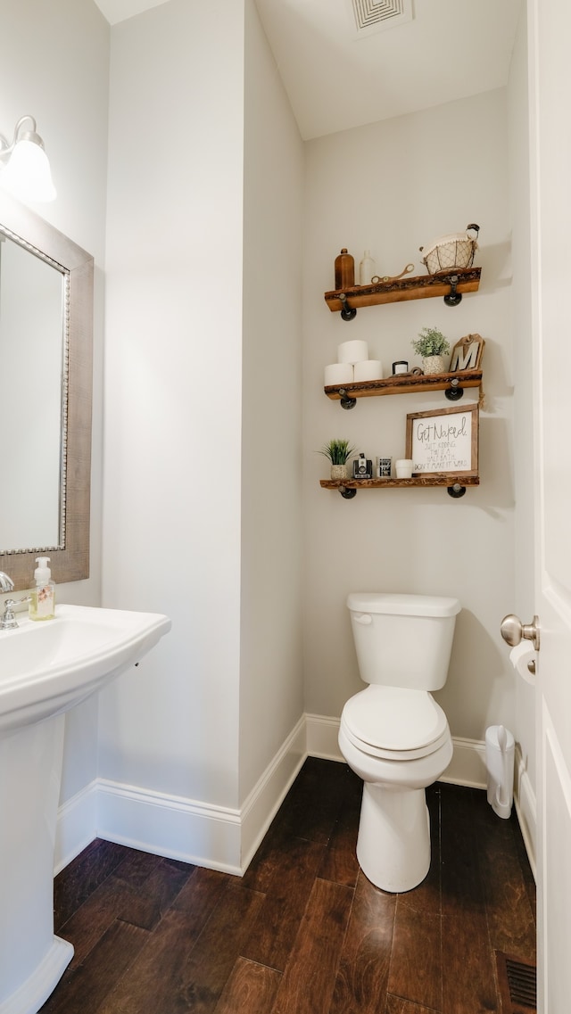 bathroom featuring hardwood / wood-style floors, toilet, and sink