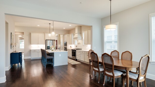 dining area with dark wood-type flooring and sink