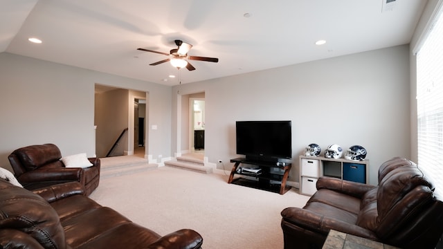 carpeted living room with ceiling fan and a healthy amount of sunlight